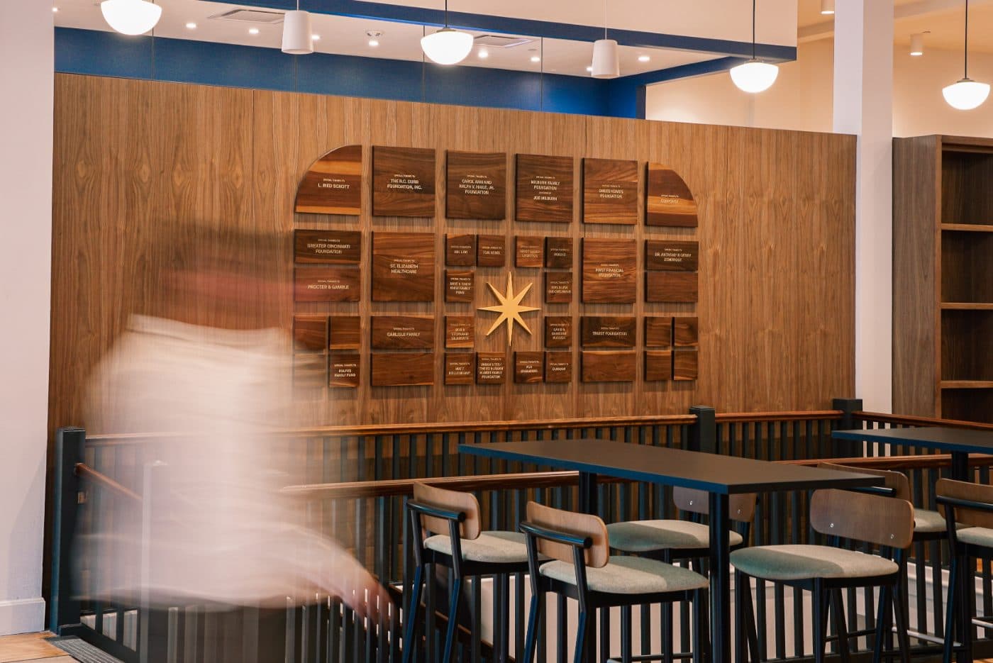 SparkHaus donor wall in walnut with a gold star